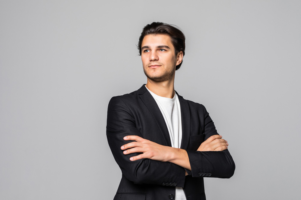 smiling-businessman-standing-with-arms-folded-isolated-white